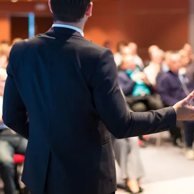 Man giving a lecture to a rapt audience.