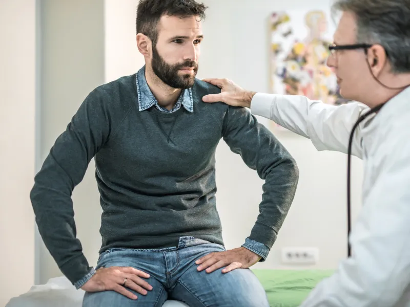 Man at doctor's office for pelvic floor issues